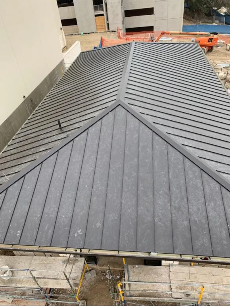 Commercial metal roof construction with crane equipment in Decatur