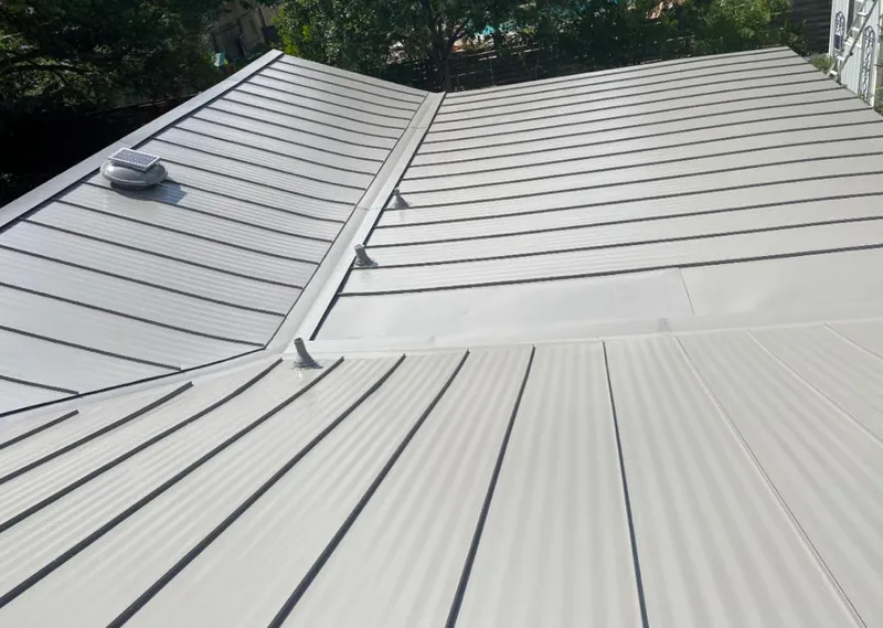 Solar attic fan installed on a metal roof for Roof Ventilation in Decatur